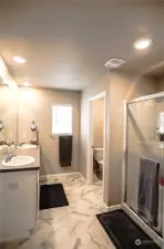 Owners Suite - dual-vanity full bath with walk-in closet to the left