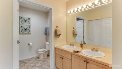 This primary en suite offers a 3/4 bath with double sinks and walk-in shower, plus 3 closets!