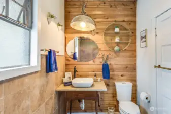 Downstairs full Bathroom with wood workmanship, surround tile and floors and jetted tub/shower combo behind