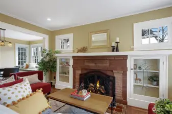 The cozy period fireplace features beautiful built-in cabinets.