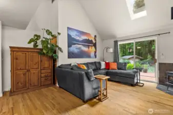 Living room with sliding doors to deck and wood stove