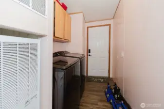 Utility area and the door to the covered car port. Furnace is less than 3 years old!