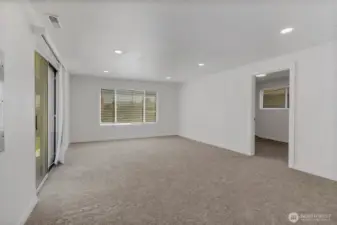 The roomy family room is carpeted for cozy gatherings