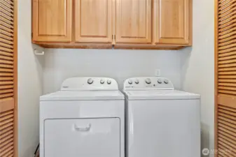 Newer washer and dryer in the utility room off of the kitchen hallway.