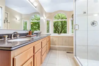Ensuite primary bathroom with double sinks, jetted tub and walk in steam shower.