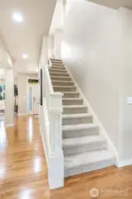 Light-filled foyer with an elegant staircase that greets you upon arrival.