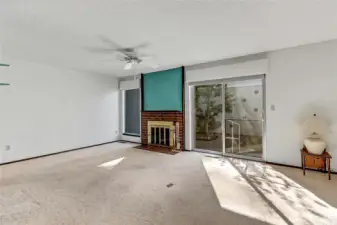 Living room w/cozy fireplace & slider to private patio