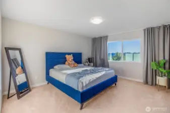 Upper floor primary bedroom with custom drapery.