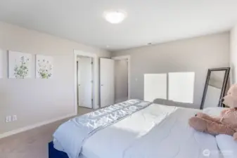 Primary bedroom is bright and spacious with walk-in closet.