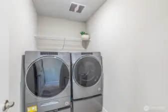 Upper floor laundry room. Full size washer and dryer stay.
