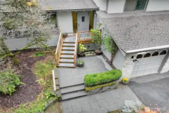 Entry with patio seating area and water feature.