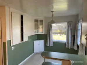 Another view of the kitchen shows built-ins and fun 50's era peninsula, plus plenty of space for a kitchen table for dining.