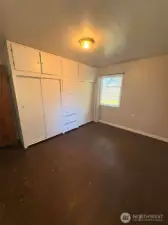 Bedroom number one has a large bank of built-ins.