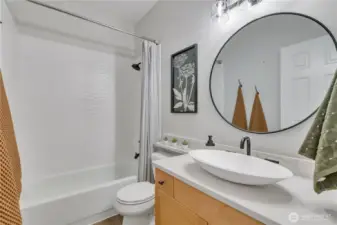 Main bathroom features a combination bathtub and shower.