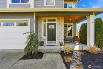 The front door welcomes guests with a covered, well-lit front patio.