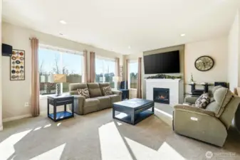 Next, flow into the open, light filled living room with southern facing windows, fireplace, and plenty of room for hanging out.