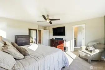 The private ensuite bathroom has everything one would expect in a luxurious home including dual sinks, separate bath, and a prive toilet.