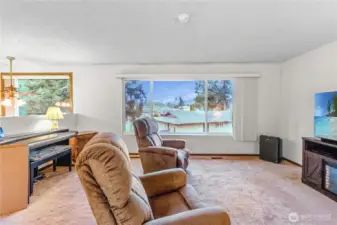 Upstairs living room w/ oversized picture window showcasing Mt. Baker views.