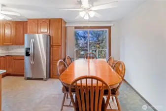 Dining area adjacent to kitchen w/ sliding door access to backyard deck.