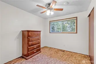 Additional upstairs bedroom w/ window overlooking the fully fenced backyard.