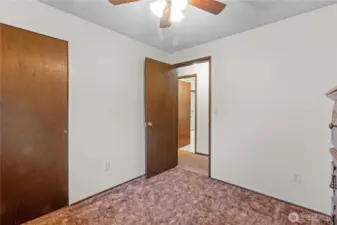 Second view of upstairs bedroom showing entry door & closet.