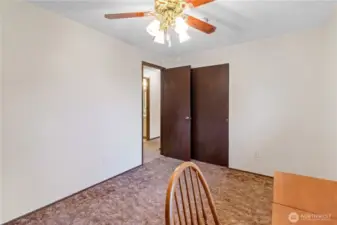 Another view of third upstairs bedroom highlighting closet storage.