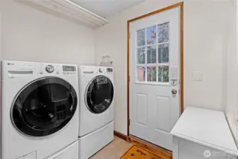 Laundry area w/ exterior door providing convenient access to the backyard.