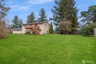 Large level backyard offering space for play, gardening or outdoor entertaining.