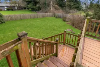 Staircase from the dining room deck leading directly to the fully fenced backyard.