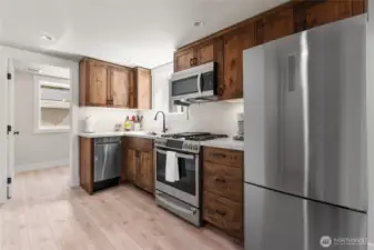 Nicely laid out kitchen with stainless appliances, gas range, & waterproof LVP flooring