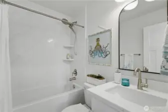 Full bathroom with quartz surround and matching quartz vanity