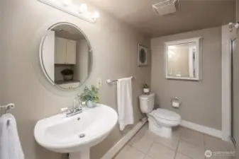 Lower level 3/4 bathroom offers cabinet space on other side of the room.