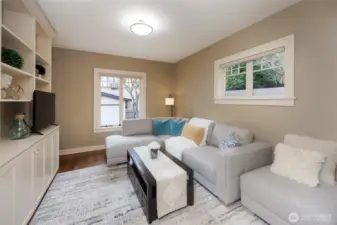 Main floor office/family room/guest bedroom featuring French doors & custom cabinetry.