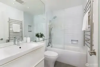 The stunning bathroom has radiant floor heat, a heated towel rack and custom finishes