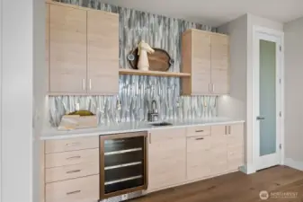 Entertaining is a breeze with a convenient sink and beverage fridge downstairs, complemented by additional Bellmont cabinetry for both style and storage.