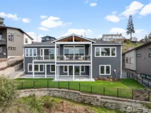 The back of the home is thoughtfully designed with covered living spaces both upstairs and downstairs. Fully fenced and equipped with full irrigation, the backyard is complete and ready for relaxation or entertaining.