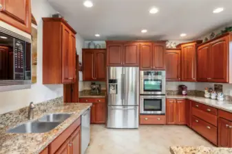 The gourmet kitchen is a chef's delight with double ovens and all stainless steel appliances.