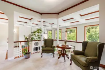 The library loft offers seating room and built in bookshelves.