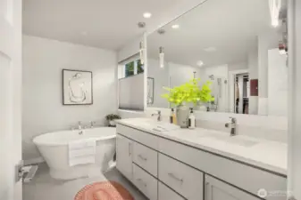 The gorgeous primary bathroom is complete with a freestanding tub and large vanity.