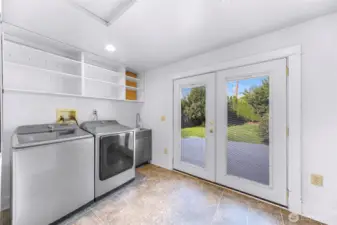 New washer and dryer in laundry room with lots of storage and French doors to back deck.