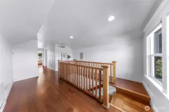 Upstairs landing has lots of room for bookshelves or storage