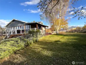 Fenced yard and western side of the home.