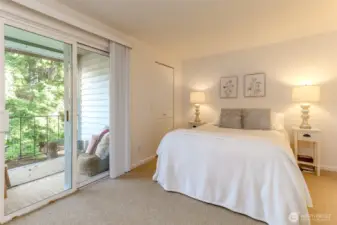 Generous primary bedroom has a lovely light neutral tone, walk-in closet (to the left of bed) and its own private balcony to enjoy.
