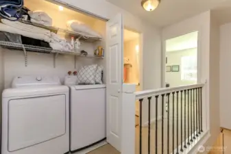 Laundry area located on upper level is discretely tucked away being closet doors.