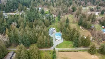 Aerial view facing North, showcasing the two ramblers (duplex style) with 40X60 shop with office - all on 5 acres located in Lake Ketchum neighborhood in Stanwood.