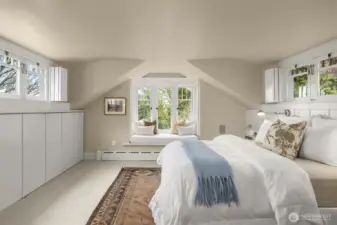 The primary bedroom has a window seat with mountain and lake views.