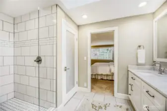 Tiled shower in master. View of privacy door on toilet.