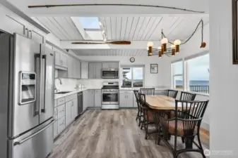 Huge kitchen with stainless Maytag appliances. Quartz counters, skylight, undercounter lighting. Cabinets are soft close and there are drawer pull outs in cabinets.