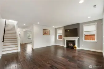 living room featuring a fireplace, large windows