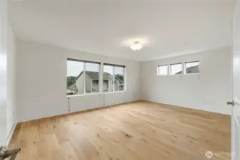 Spacious primary bedroom with abundant natural light
